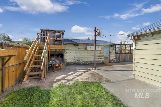 exterior space with a patio area, fence, and stairway