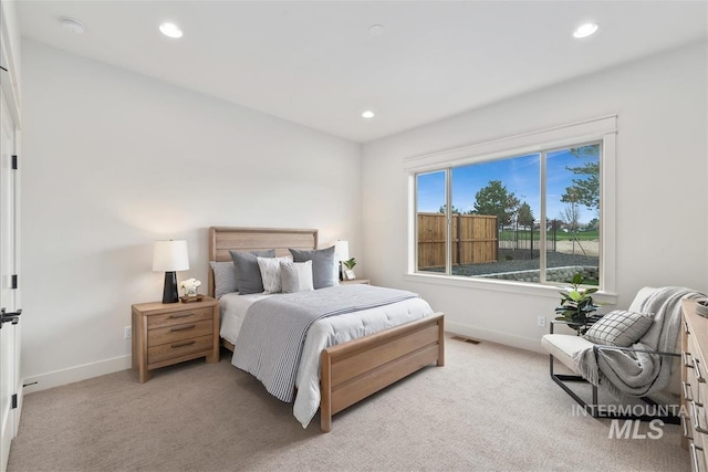 bedroom featuring recessed lighting, light carpet, and baseboards