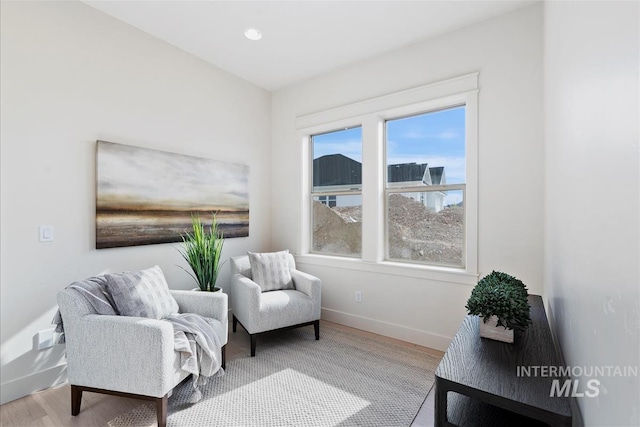 sitting room with wood finished floors and baseboards