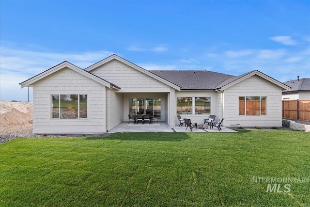 back of house with a yard, a patio area, and fence