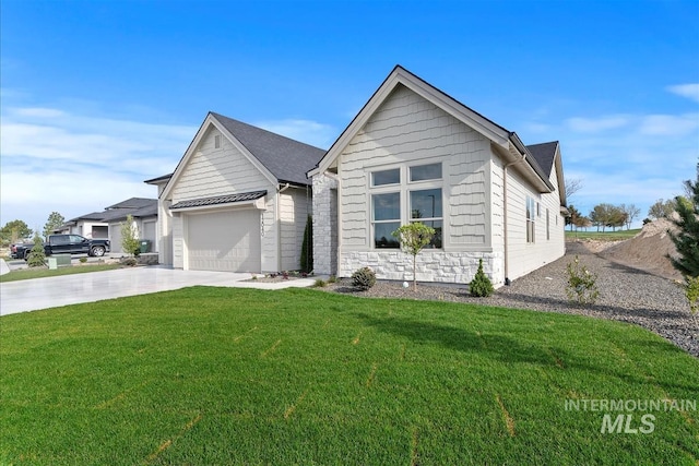 view of front facade with stone siding, a front yard, concrete driveway, and an attached garage