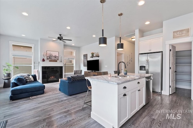 3090 NW 13th St, Meridian, ID 83646 - kitchen featuring visible vents, a sink, dark wood-style floors, open floor plan, and stainless steel appliances