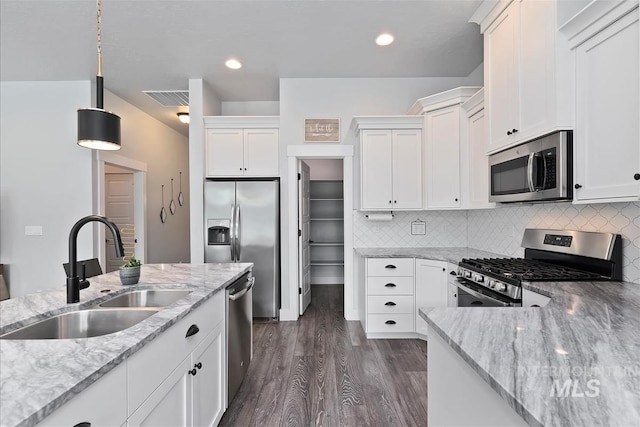 3090 NW 13th St, Meridian, ID 83646 - kitchen featuring a sink, appliances with stainless steel finishes, light stone counters, and white cabinetry