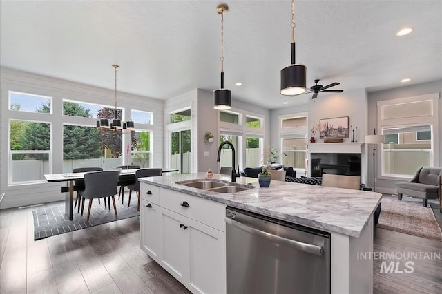 3090 NW 13th St, Meridian, ID 83646 - kitchen featuring stainless steel dishwasher, a glass covered fireplace, recessed lighting, a sink, and dark wood finished floors