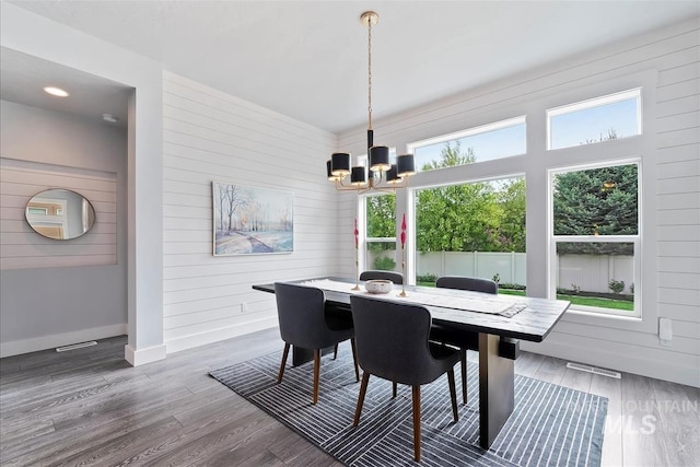 3090 NW 13th St, Meridian, ID 83646 - dining room featuring wooden walls, baseboards, a notable chandelier, and wood finished floors