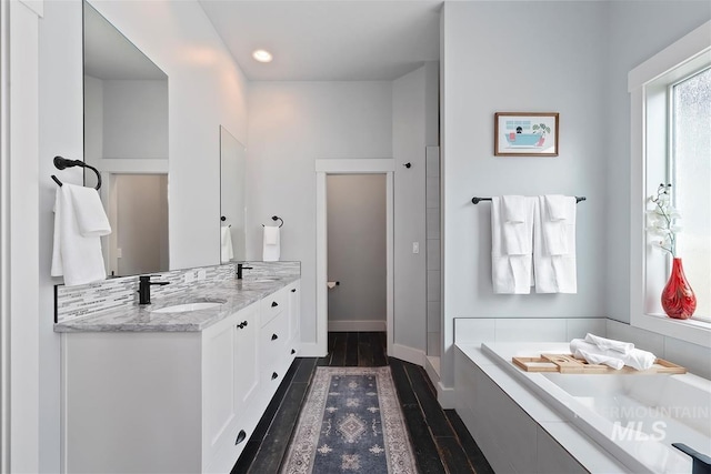 3090 NW 13th St, Meridian, ID 83646 - full bathroom with vanity, wood finished floors, baseboards, recessed lighting, and a bath