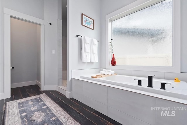3090 NW 13th St, Meridian, ID 83646 - full bathroom with a shower, baseboards, a bathtub, and wood finished floors