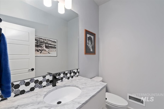3090 NW 13th St, Meridian, ID 83646 - half bath with visible vents, tasteful backsplash, toilet, and vanity
