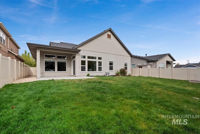3090 NW 13th St, Meridian, ID 83646 - rear view of property with a fenced backyard, a patio area, stucco siding, and a yard