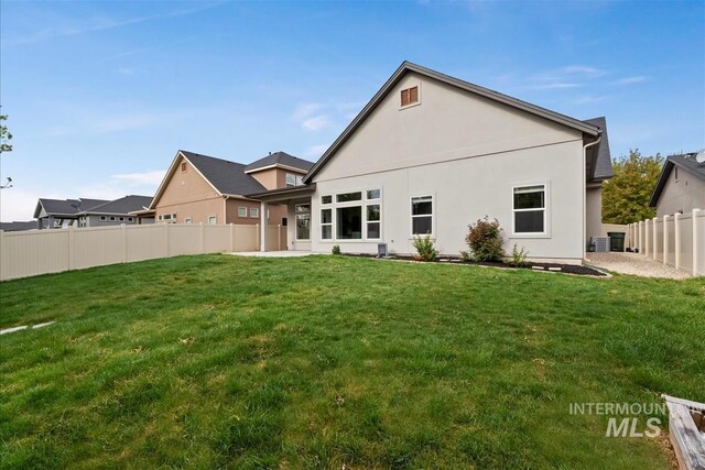 3090 NW 13th St, Meridian, ID 83646 - back of property with a lawn, stucco siding, and a fenced backyard