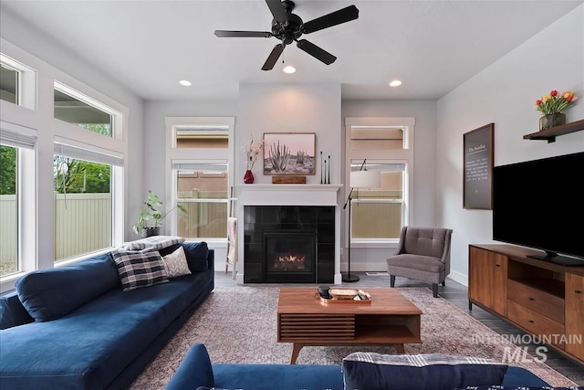 3090 NW 13th St, Meridian, ID 83646 - living room featuring a tiled fireplace, recessed lighting, baseboards, and ceiling fan