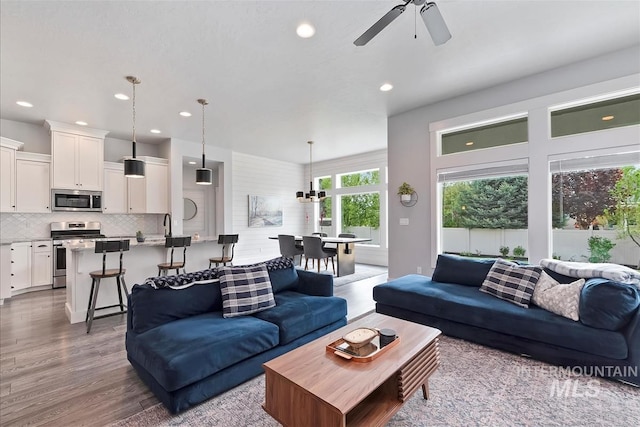 3090 NW 13th St, Meridian, ID 83646 - living room with recessed lighting, wood finished floors, and ceiling fan with notable chandelier