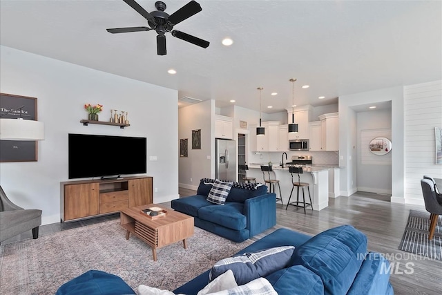 3090 NW 13th St, Meridian, ID 83646 - living area featuring dark wood-style flooring, baseboards, recessed lighting, and ceiling fan
