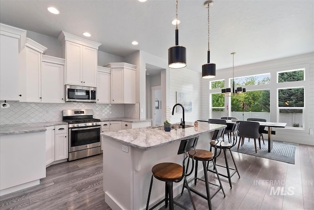 3090 NW 13th St, Meridian, ID 83646 - kitchen featuring a sink, stainless steel appliances, white cabinetry, and dark wood-type flooring