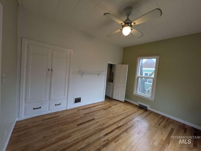 unfurnished bedroom with light wood finished floors, baseboards, and visible vents