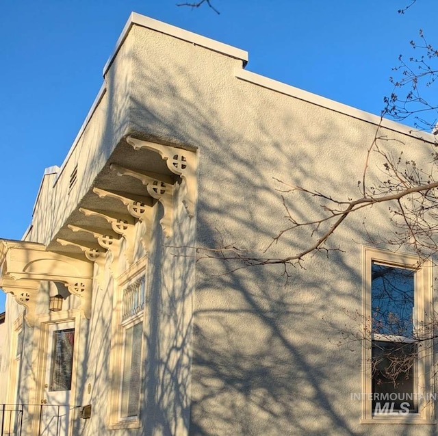 view of side of property featuring stucco siding