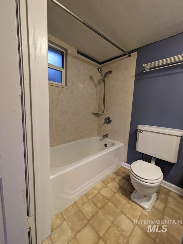 bathroom featuring baseboards, shower / bathing tub combination, and toilet