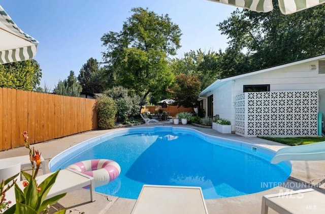 view of pool featuring a patio area and a water slide