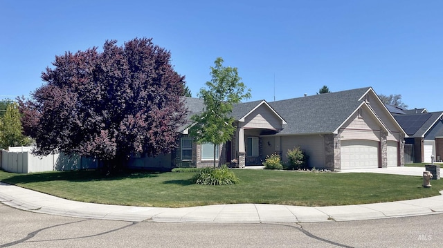 view of front of property with a garage and a front lawn