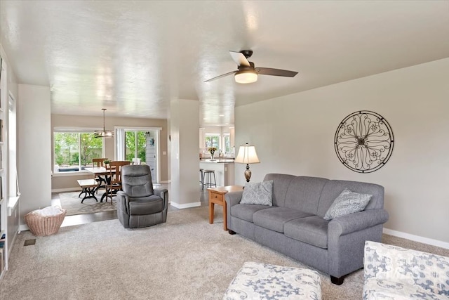 12131 W Precept Ln, Kuna, ID 83634 - living area with baseboards, a ceiling fan, and light carpet