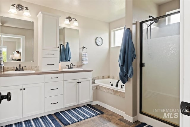 12131 W Precept Ln, Kuna, ID 83634 - bathroom featuring a stall shower, a bath, double vanity, and stone finish flooring