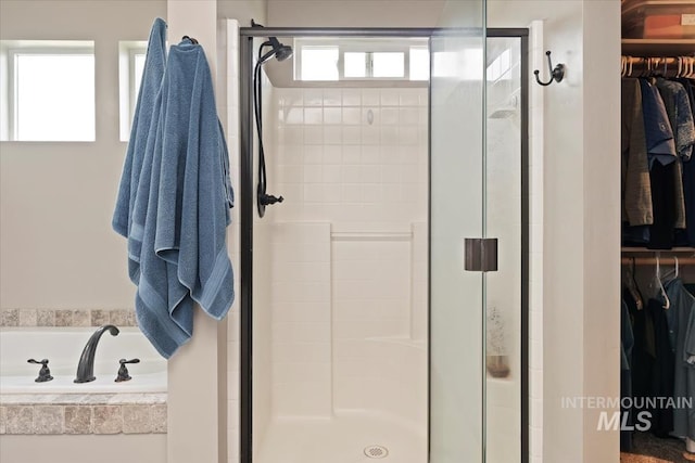 12131 W Precept Ln, Kuna, ID 83634 - bathroom featuring a shower stall, a garden tub, and a walk in closet