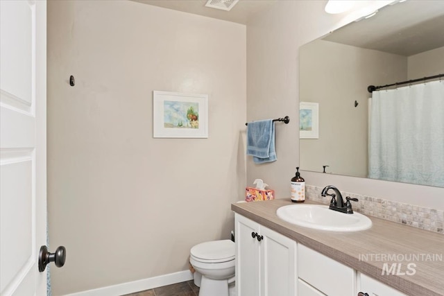 12131 W Precept Ln, Kuna, ID 83634 - bathroom with vanity, toilet, and tasteful backsplash