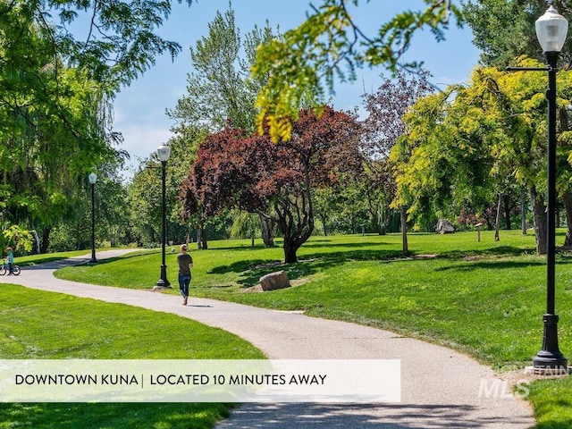 12131 W Precept Ln, Kuna, ID 83634 - view of community featuring a yard and view of wooded area
