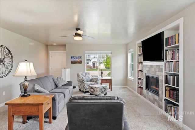12131 W Precept Ln, Kuna, ID 83634 - carpeted living area with a tile fireplace, baseboards, ceiling fan, and built in features