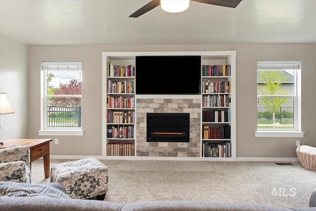 12131 W Precept Ln, Kuna, ID 83634 - living area featuring carpet floors, baseboards, a glass covered fireplace, and plenty of natural light