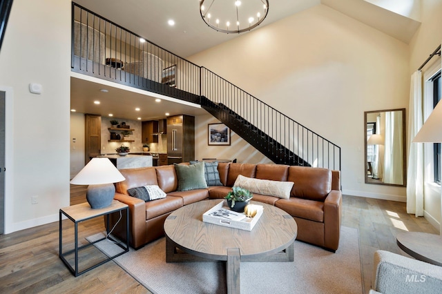 700 Village Dr Unit 402, Donnelly, ID 83615 - living room featuring a notable chandelier, a towering ceiling, and wood-type flooring