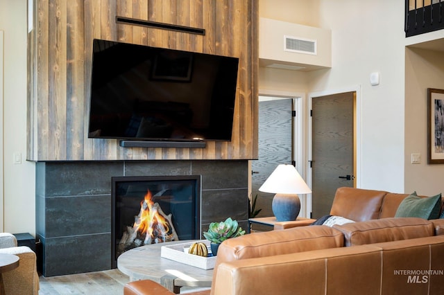 living room featuring wood-type flooring and a fireplace