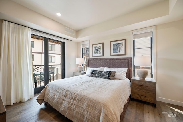 bedroom featuring dark wood-type flooring and access to outside