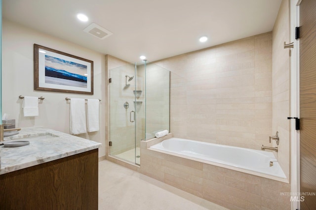 bathroom featuring shower with separate bathtub and vanity