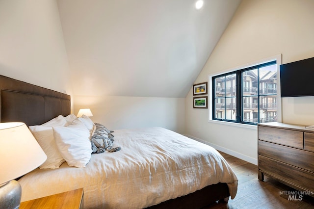 bedroom featuring lofted ceiling and hardwood / wood-style floors