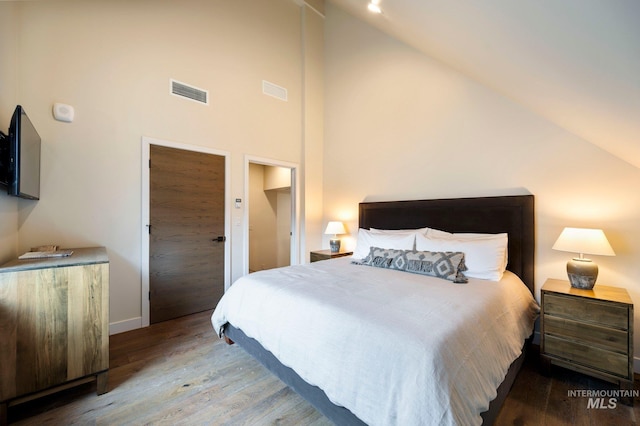 bedroom featuring hardwood / wood-style flooring and vaulted ceiling