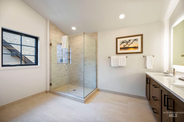 bathroom featuring vanity and a shower with shower door