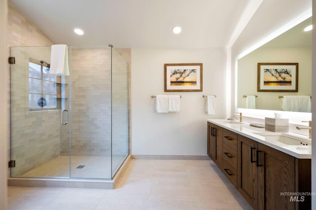 bathroom featuring vanity and a shower with door