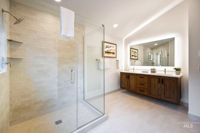 bathroom with vanity, an enclosed shower, and vaulted ceiling