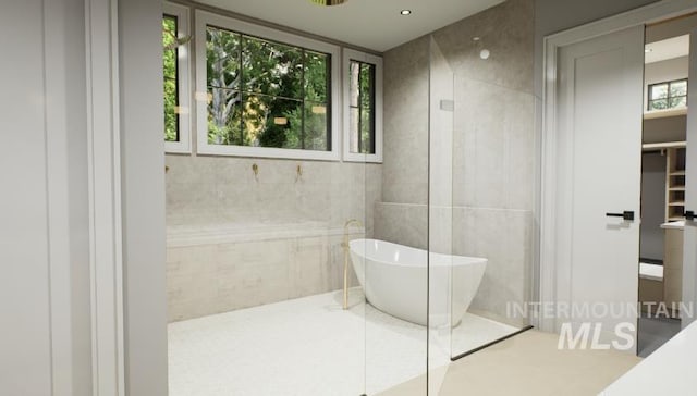 1054 N Delehaye Ave, Eagle, ID 83616 - bathroom with a freestanding bath, tile walls, and tiled shower