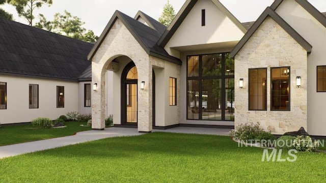 1054 N Delehaye Ave, Eagle, ID 83616 - french country inspired facade with stone siding, a front yard, and stucco siding