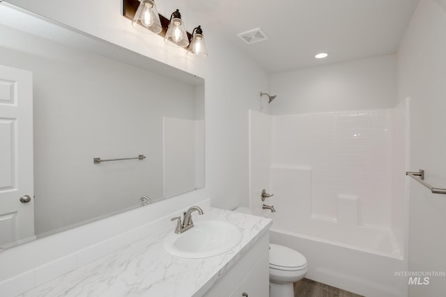 full bathroom featuring toilet, shower / bath combination, vanity, and visible vents