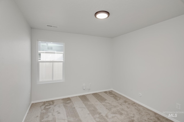 unfurnished room with light carpet, baseboards, and visible vents