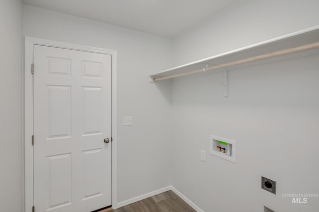 laundry area featuring hookup for an electric dryer, laundry area, dark wood-type flooring, washer hookup, and baseboards