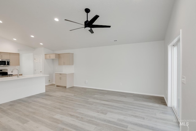 unfurnished living room featuring ceiling fan, light wood-type flooring, vaulted ceiling, and recessed lighting