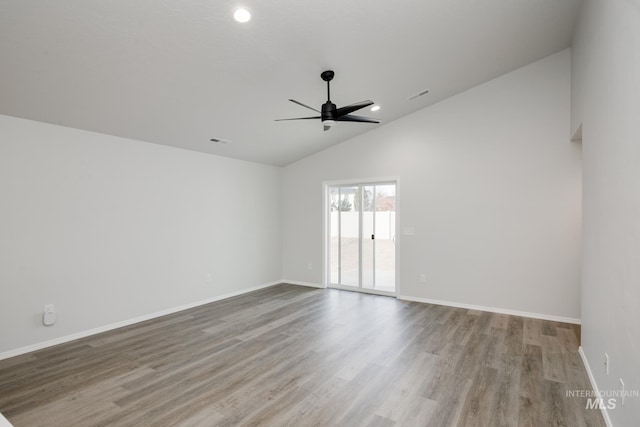 spare room with ceiling fan, baseboards, and wood finished floors