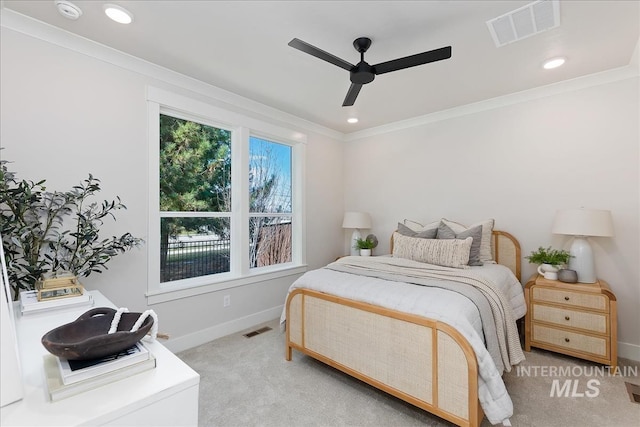 bedroom with crown molding, baseboards, visible vents, and light carpet