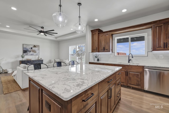 3675 E 3711 N, Kimberly, ID 83341 - kitchen with dishwasher, a sink, light wood-style flooring, tasteful backsplash, and a center island