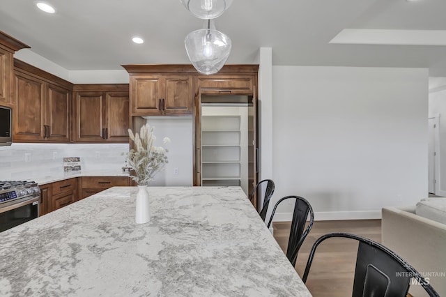 3675 E 3711 N, Kimberly, ID 83341 - kitchen featuring dark wood-style floors, light stone countertops, recessed lighting, baseboards, and pendant lighting