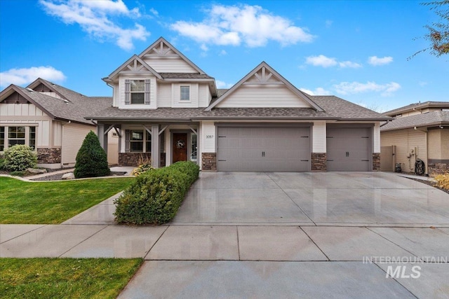 craftsman inspired home featuring a front yard and a garage